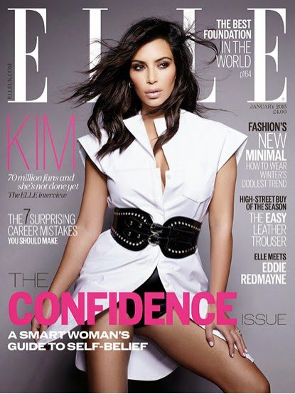 Kim Kardashian West in a white shirt and thick leather belt on the cover of Elle.